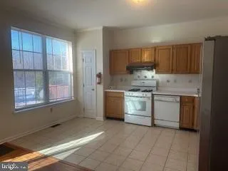 a kitchen with a stove sink and cabinets