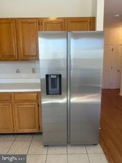 a kitchen with a refrigerator and cabinets