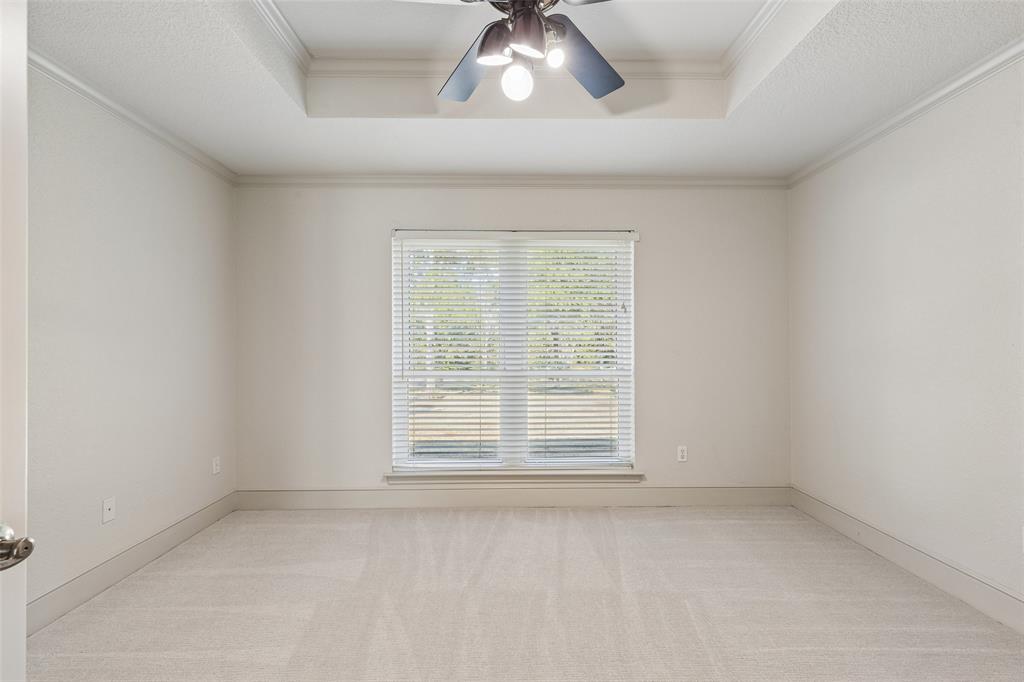 1155 Point Vista Road Hickory Creek, TX 75065 - Photo 19 of 40 Tray ceiling with crown molding, ceiling fan with light fixture, carpet flooring, and a large window with blinds