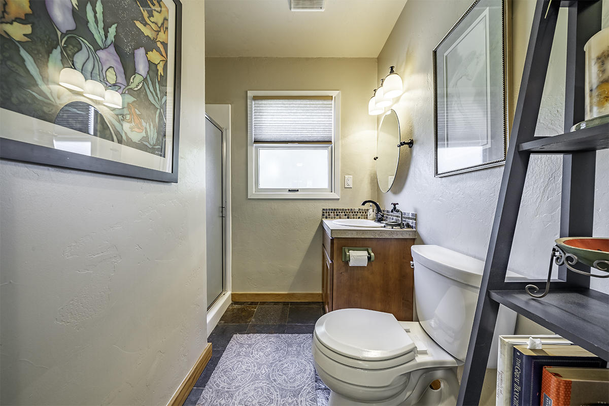 7785 Old Stage Road Central Point, OR 97502 - Photo 20 of 47 a bathroom with a toilet a sink and a mirror