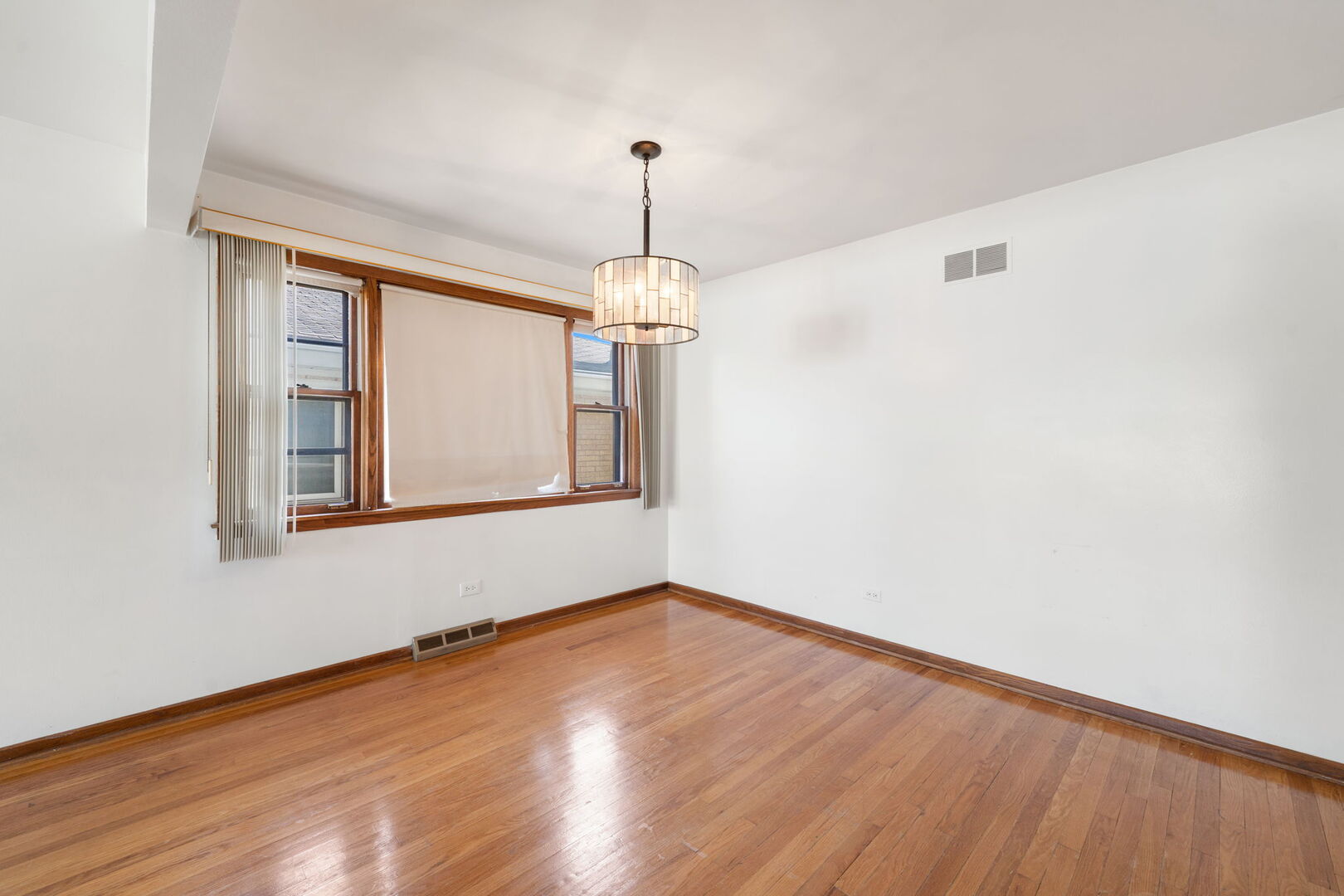 8427 West Windsor Avenue, Unit 1 Chicago, IL 60656 - Photo 12 of 34 a view of an empty room with wooden floor and a window