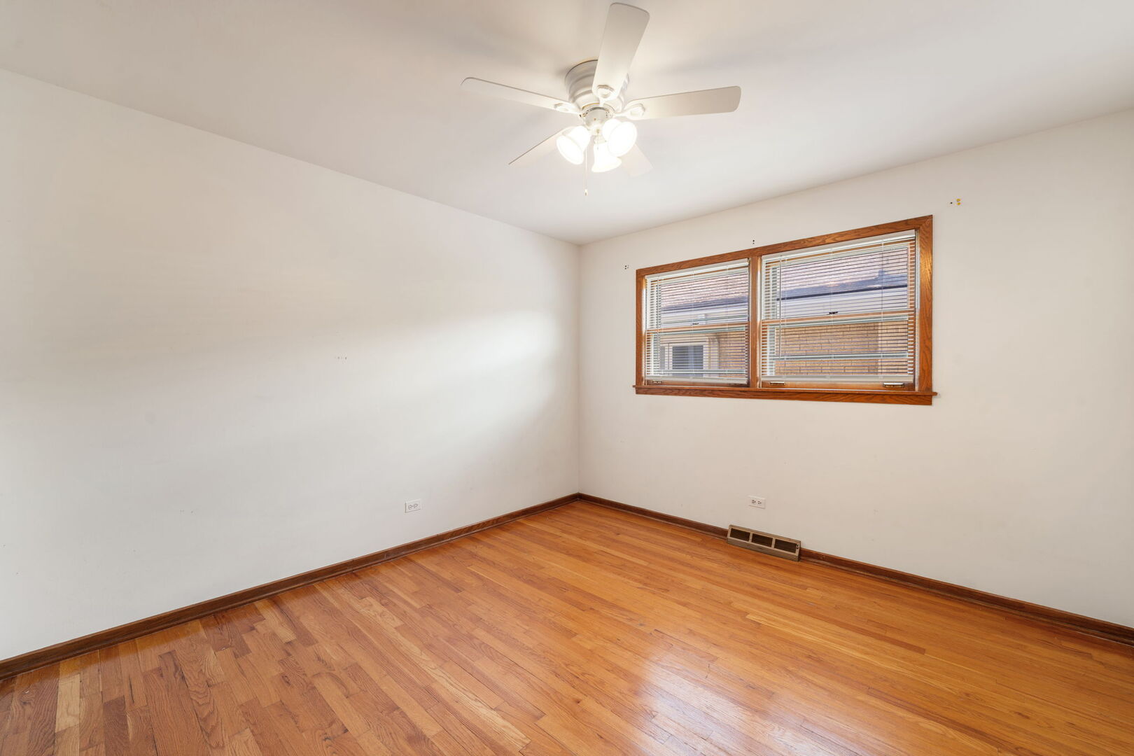 8427 West Windsor Avenue, Unit 1 Chicago, IL 60656 - Photo 19 of 34 wooden floor in an empty room with a window