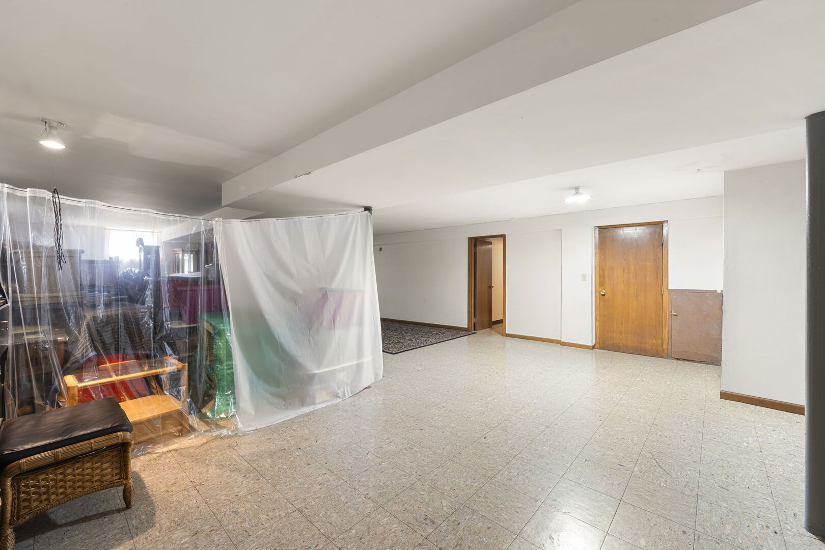 8427 West Windsor Avenue, Unit 1 Chicago, IL 60656 - Photo 22 of 34 an empty room with stairs and a couch