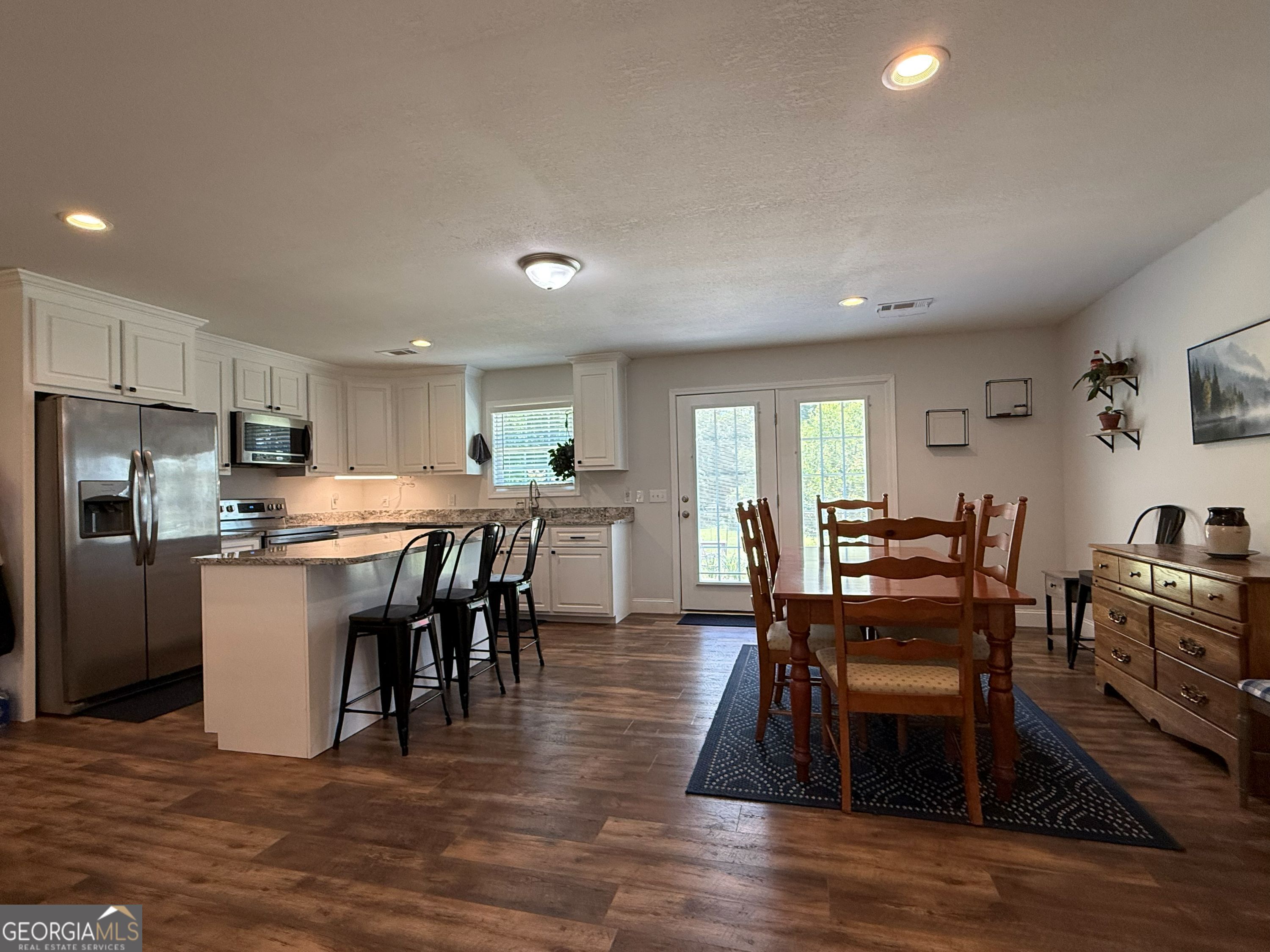 365 Quail Lane Alston, GA 30473 - Photo 2 of 9 a view of kitchen with refrigerator dining table and chairs