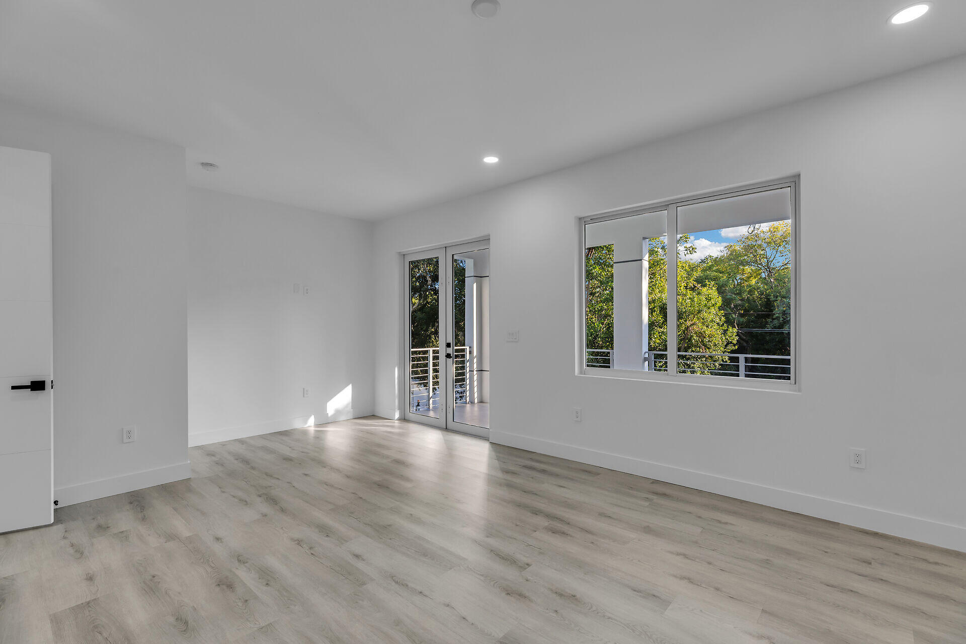 46 Transylvania Avenue Key Largo, FL 33037 - Photo 21 of 52 a view of an empty room with wooden floor and a window