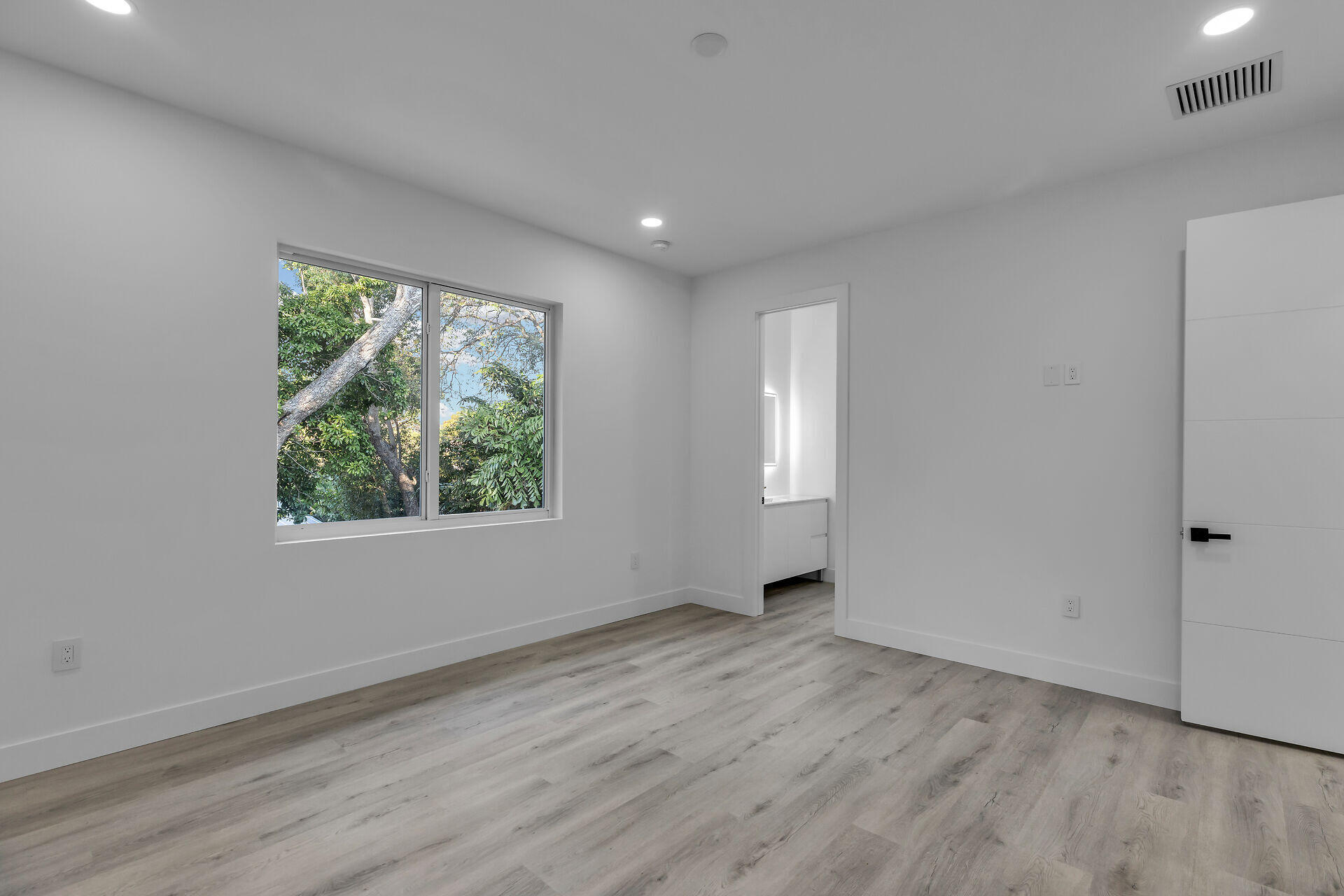 46 Transylvania Avenue Key Largo, FL 33037 - Photo 30 of 52 an empty room with wooden floor and windows