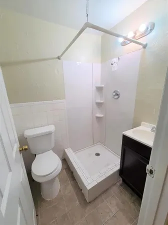 a white toilet sitting next to a bathroom sink