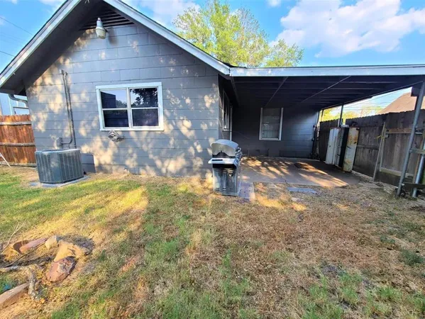 a backyard of a house with yard and outdoor seating