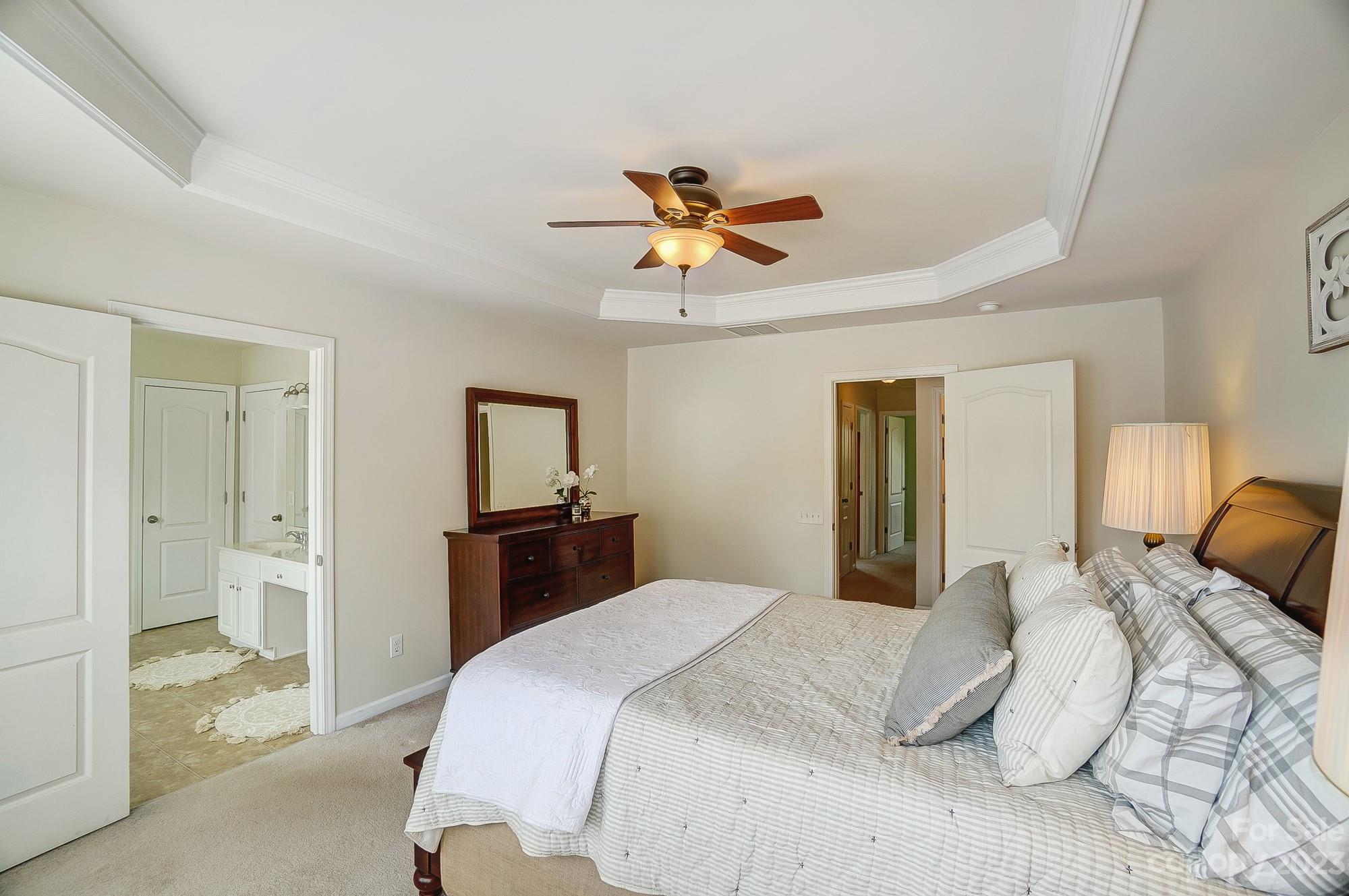 2512 Coltsgate Road Waxhaw, NC 28173 - Photo 25 of 48 a bedroom with a bed and a chandelier