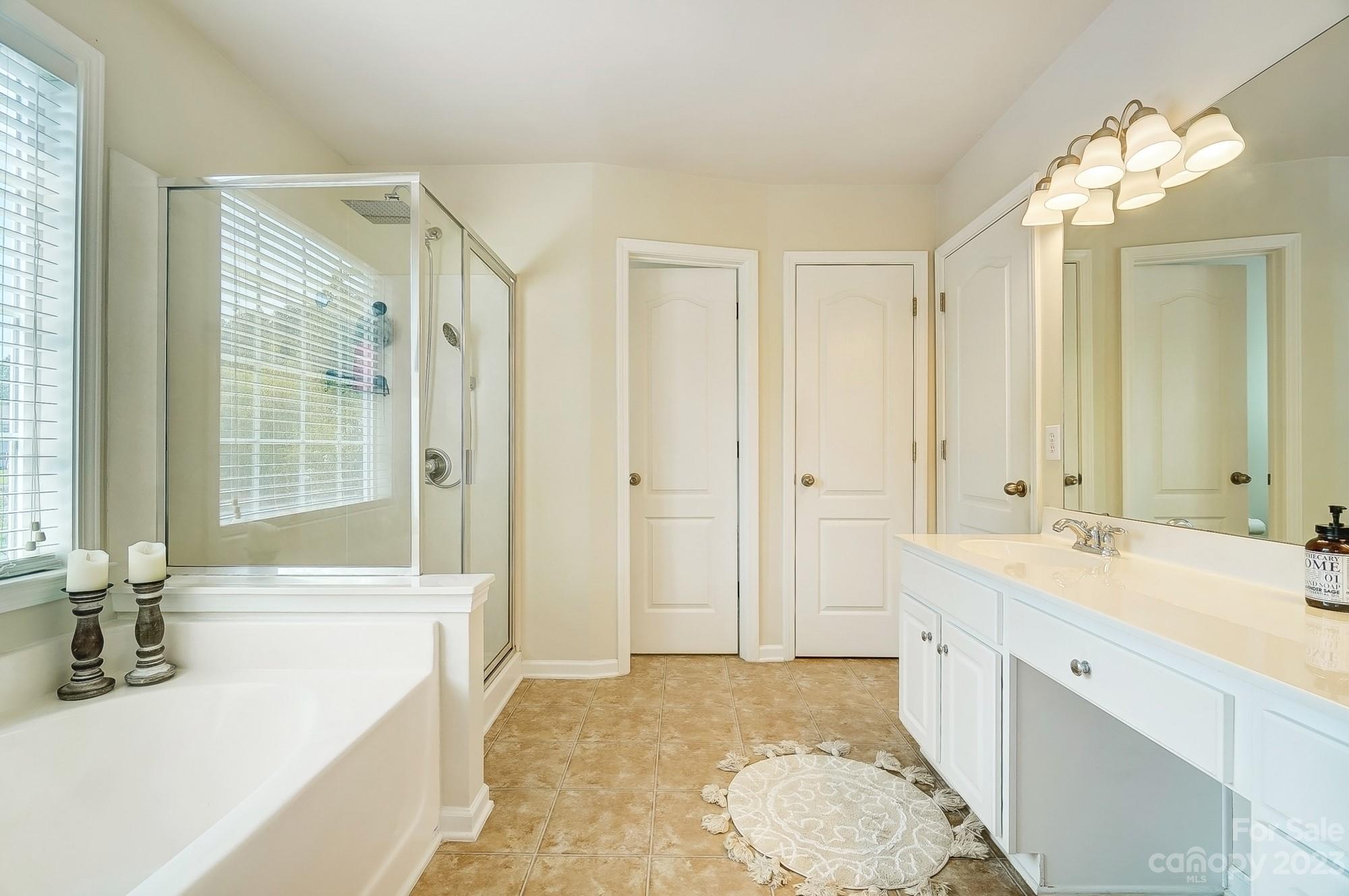 2512 Coltsgate Road Waxhaw, NC 28173 - Photo 26 of 48 a spacious bathroom with a tub sink and mirror