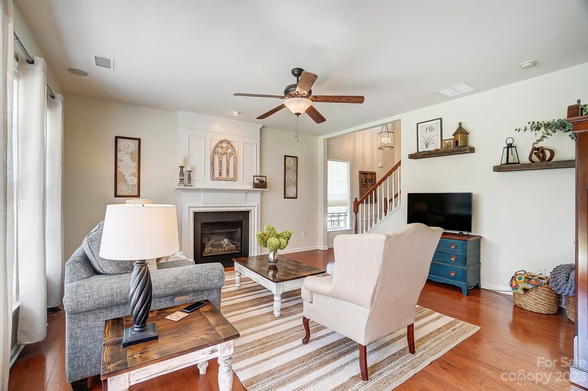 2512 Coltsgate Road Waxhaw, NC 28173 - Photo 6 of 48 a living room with furniture a flat screen tv and a fireplace