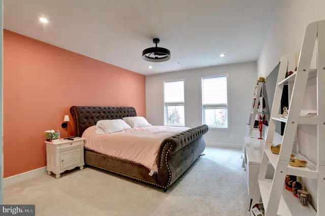 a spacious bedroom with a bed and a window