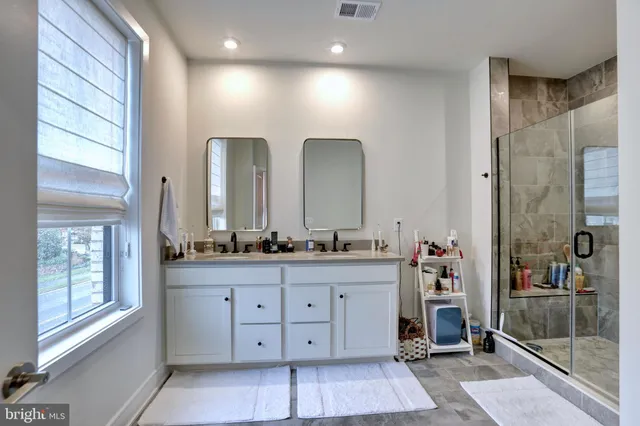 a bathroom with a double vanity sink and a mirror