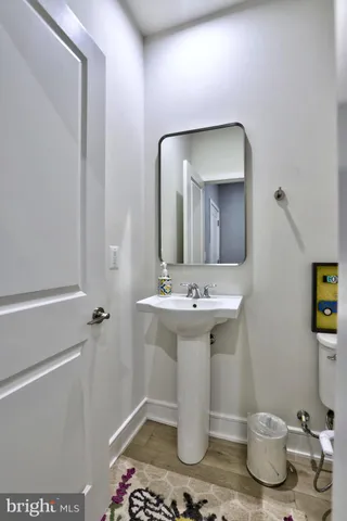 a bathroom with a sink toilet and mirror