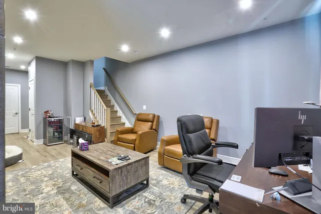 a living room with furniture a rug and a piano