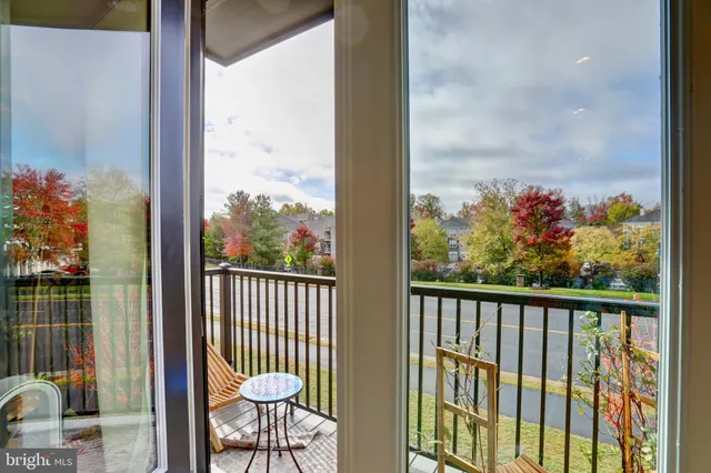 a view of a balcony with chair and wooden floor