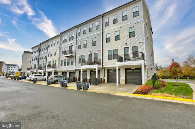 a view of a building with cars parked in front of it