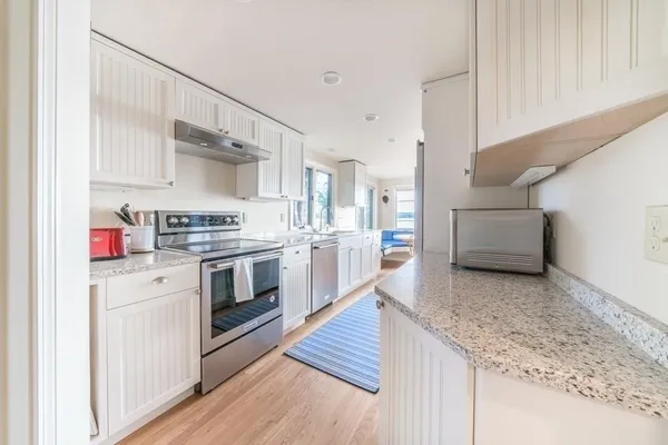 a kitchen with stainless steel appliances granite countertop a sink and cabinets