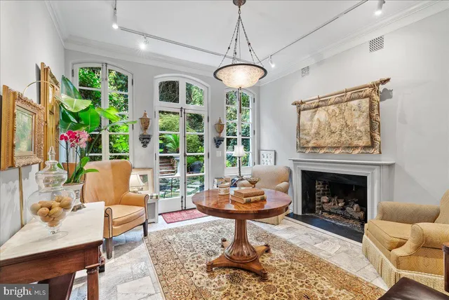 a living room with furniture a fireplace and a table