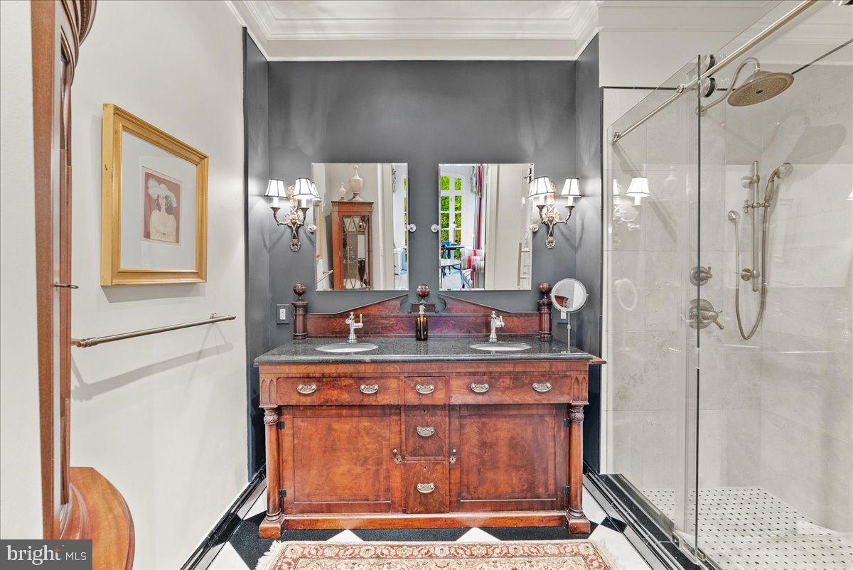 2815 Q Street Northwest Washington, DC 20007 - Photo 16 of 30 a view of a bathroom with a sink a mirror and a shower