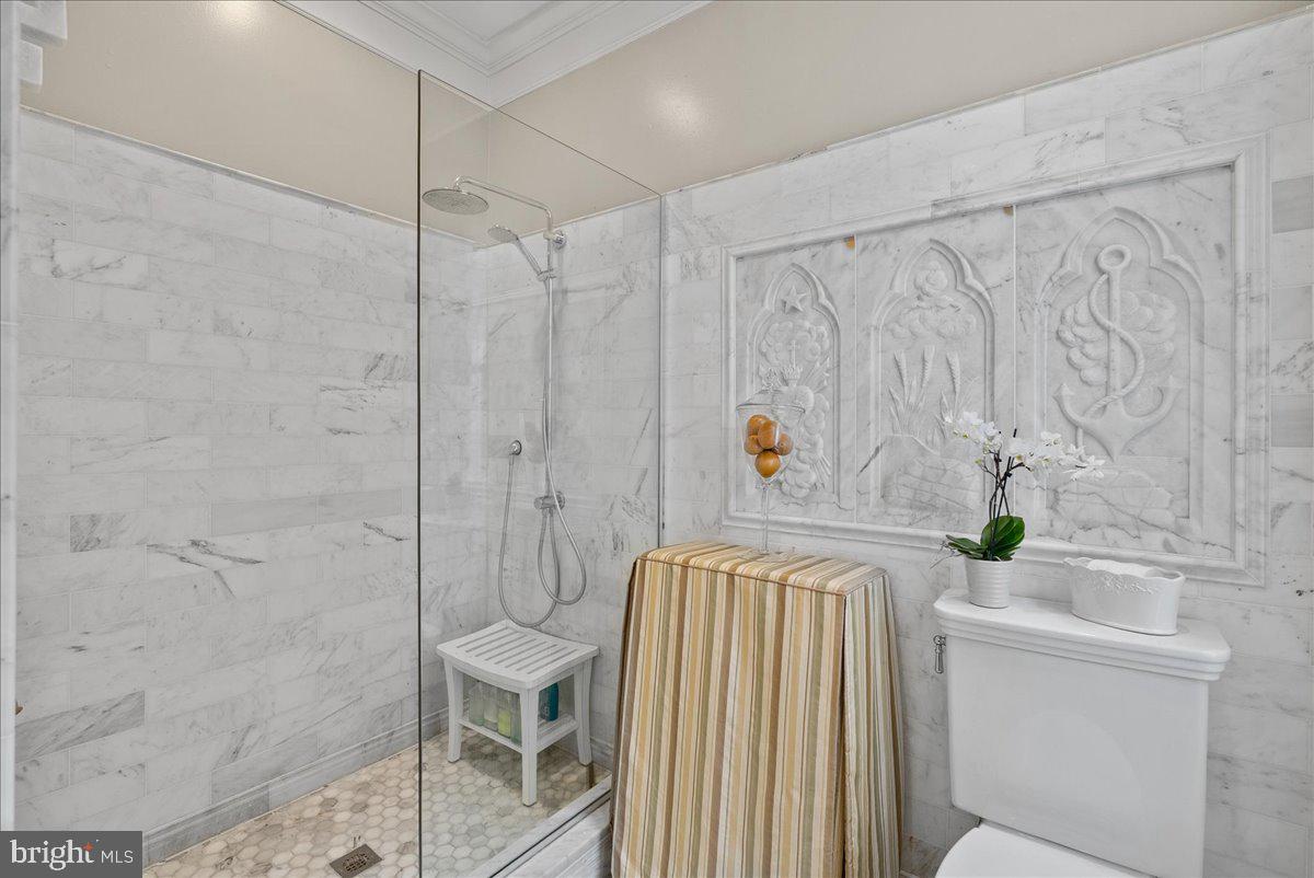 2815 Q Street Northwest Washington, DC 20007 - Photo 19 of 30 a bathroom with a sink a toilet and shower curtain