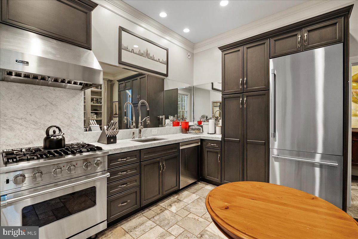 2815 Q Street Northwest Washington, DC 20007 - Photo 9 of 30 a kitchen with stainless steel appliances a refrigerator sink and stove
