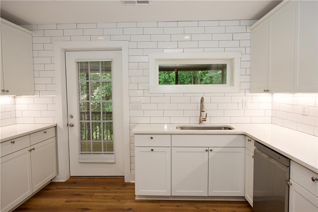 317 Pendleton Road Clemson, SC 29631 - Photo 13 of 36 A well-lit kitchen with sleek white cabinetry and a practical walk-out access point.