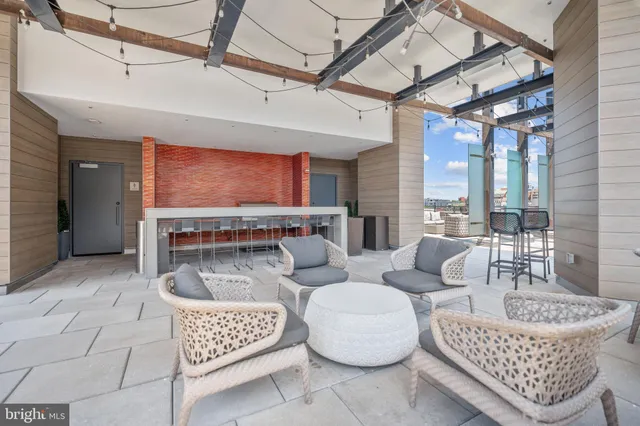 a living room with furniture and a floor to ceiling window
