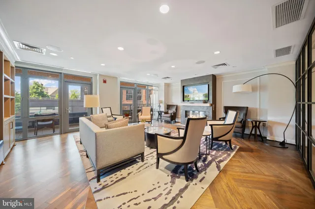 a living room with furniture a window and kitchen view