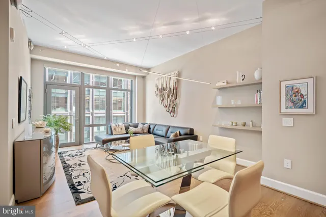 a dining room with furniture and a large window