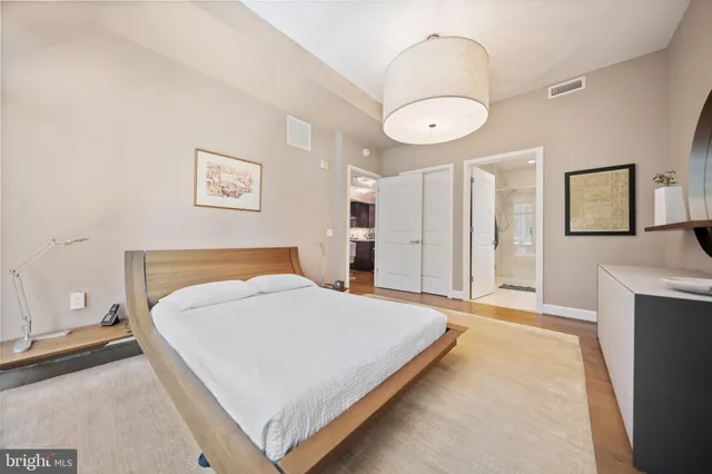 a bedroom with a bed and a chandelier