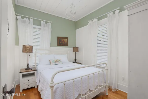 a bedroom with a bed and a night stand