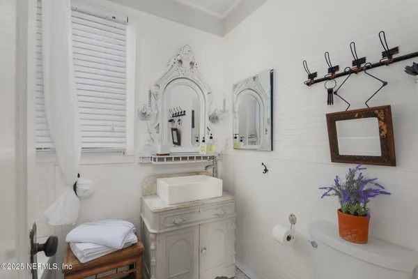 a bathroom with a sink mirror toilet and vanity