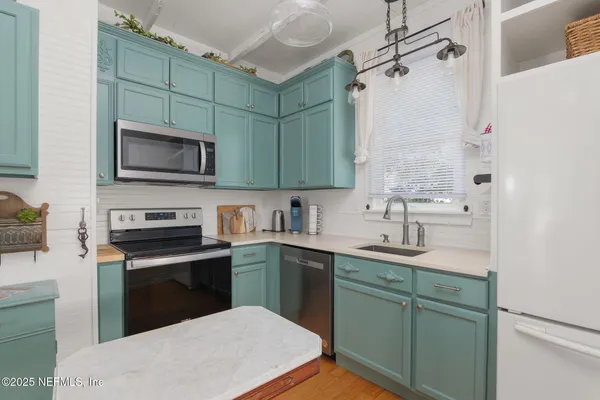 a kitchen with a sink stove and microwave