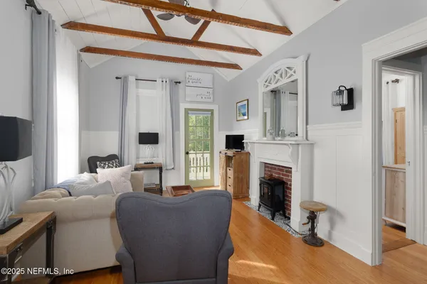 a living room with furniture a fireplace and a flat screen tv