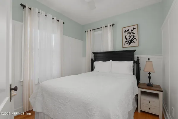 a bed room with a bed and a night stand
