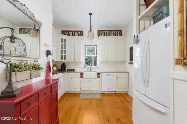a kitchen with stainless steel appliances a stove a sink and a refrigerator