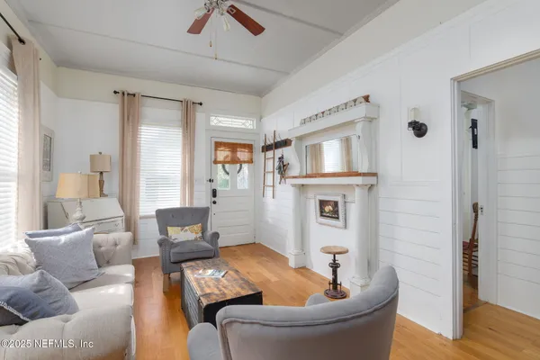 a living room with furniture and a fireplace