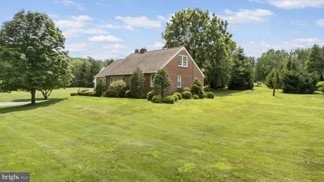 a view of house with yard and green space