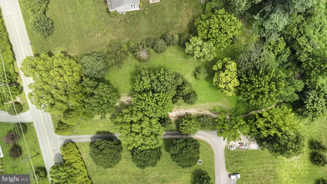 an aerial view of residential houses with outdoor space and swimming pool
