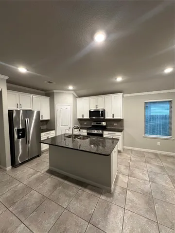 a kitchen with stainless steel appliances granite countertop a sink and cabinets