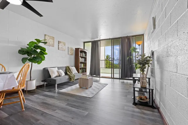 a living room with furniture and a potted plant