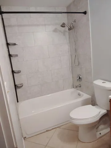 a bathroom with a toilet and a bath tub
