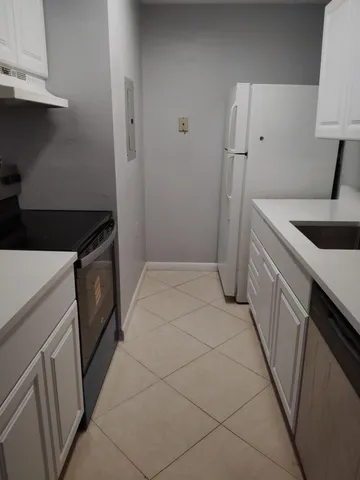 a kitchen with a sink stove and refrigerator