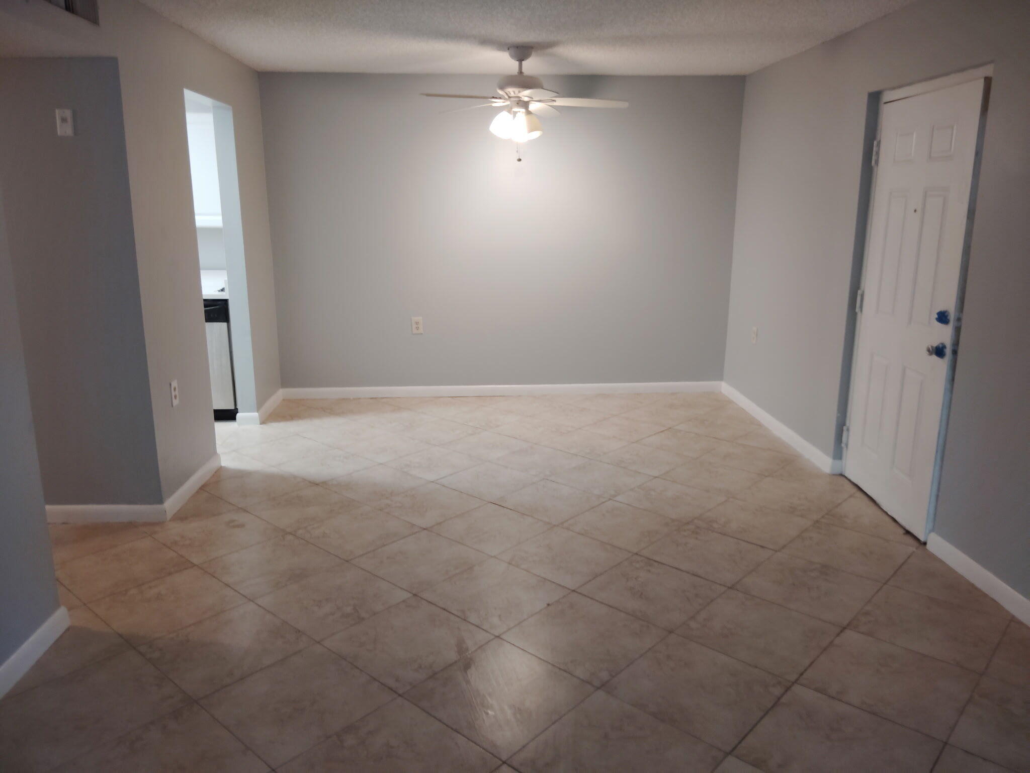 1140 Lake Victoria Drive, Unit M West Palm Beach, FL 33411 - Photo 6 of 8 an empty room with fan and entrance