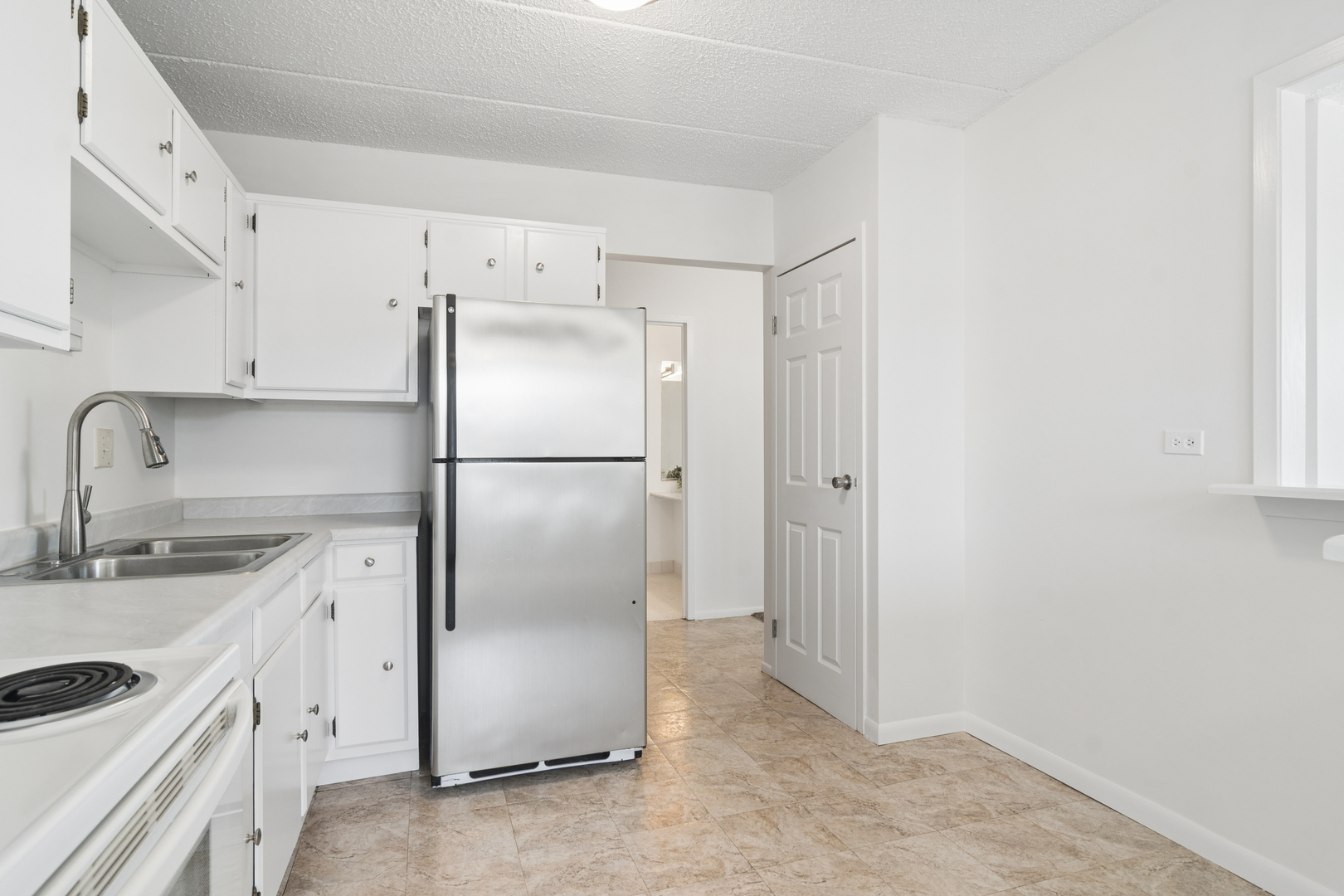 9701 North Dee Road, Unit 6N Niles, IL 60714 - Photo 5 of 13 a kitchen with a refrigerator sink and cabinets