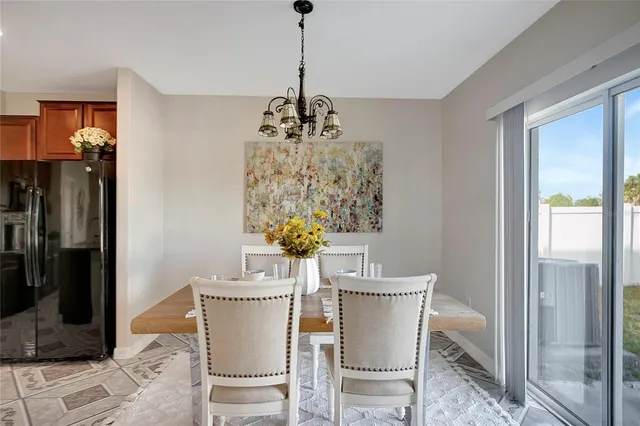 a view of a dining room with furniture and a chandelier