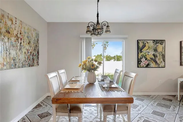 a living room with furniture a potted plant and a large window