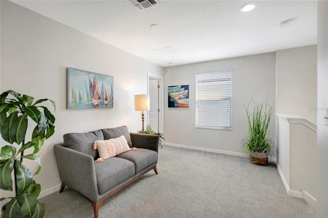 a bedroom with a bed and a potted plant