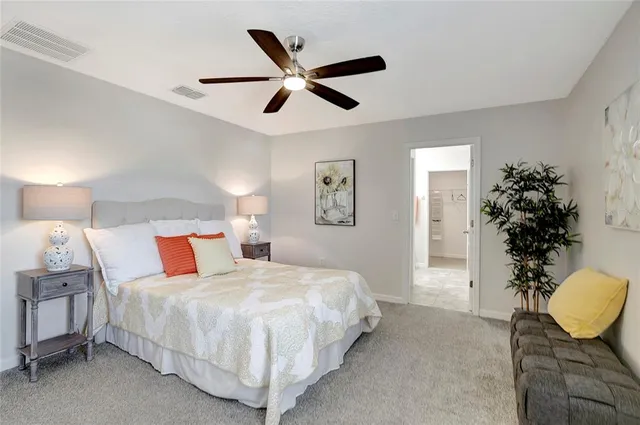 a bedroom with a bed and a potted plant